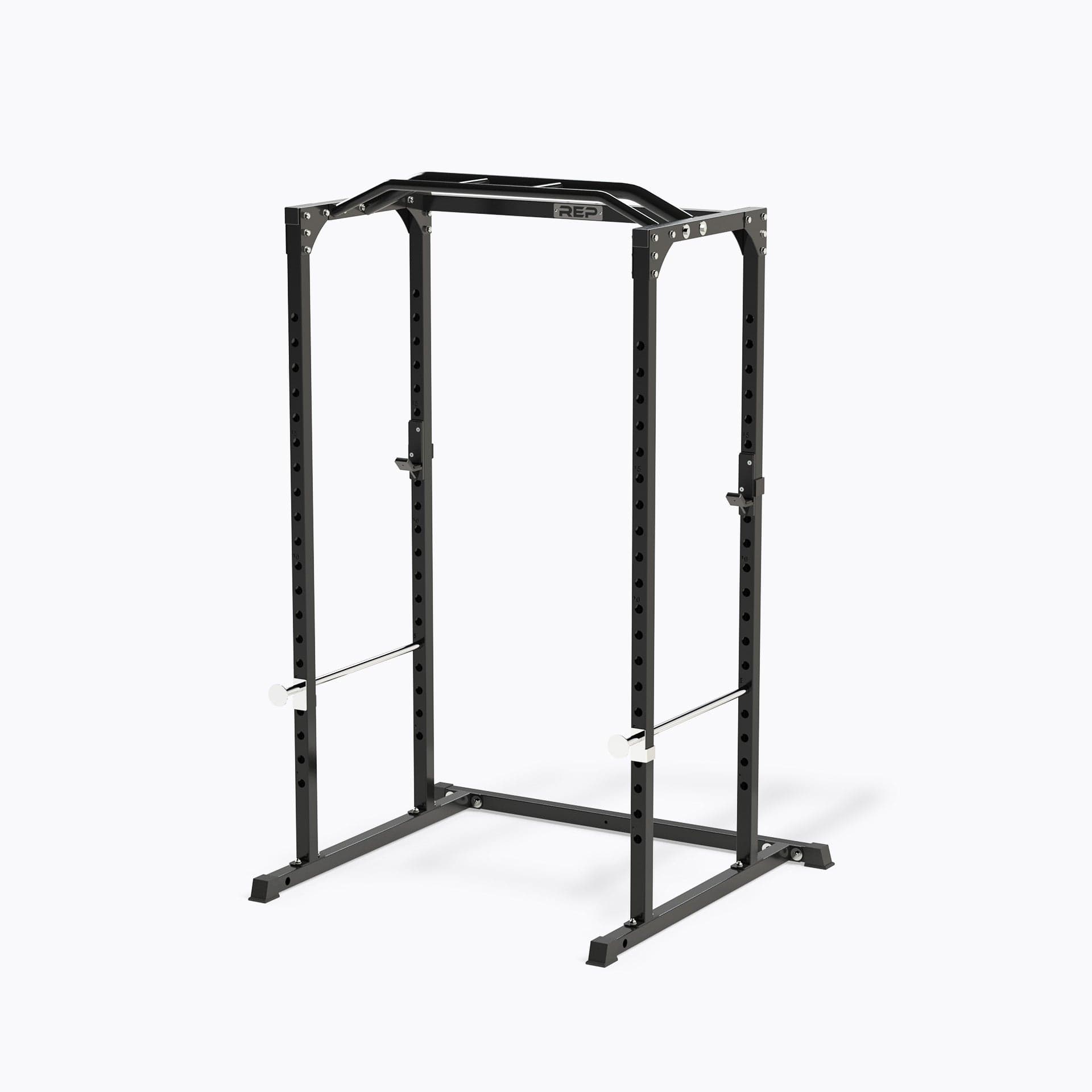 REP PR-1100 power rack shown in metallic black with multi-grip pull-up bar and safety hardware