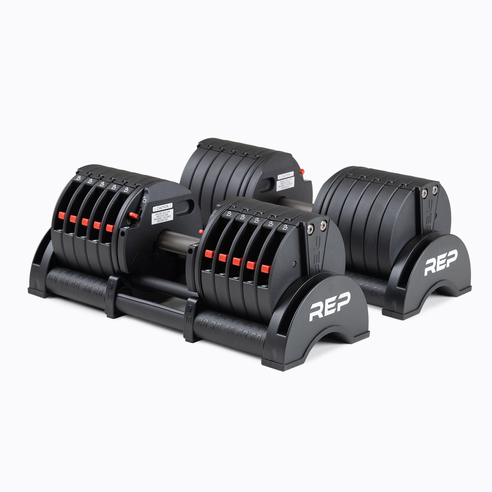 REP QuickDraw adjustable dumbbells shown together with their storage cradle