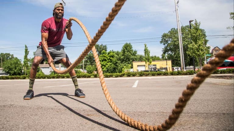 Rogue Conditioning Rope shown as a coiled brown manila rope with handles